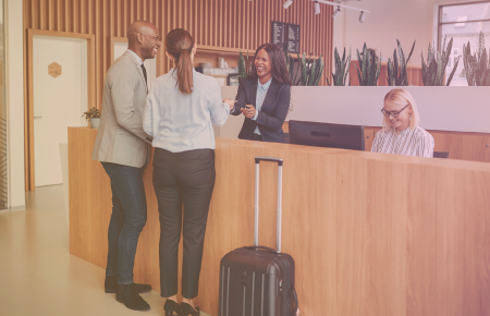 Happy couple checking in to hotel