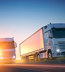Freight trucks riding into the sunset